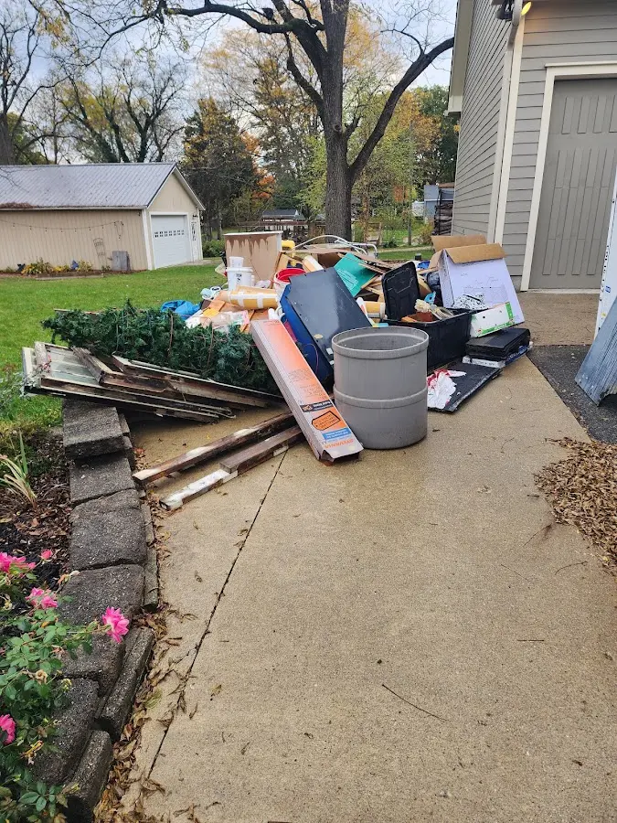 Dumpster being loaded with debris for Residential Dumpster Rental in Grafton